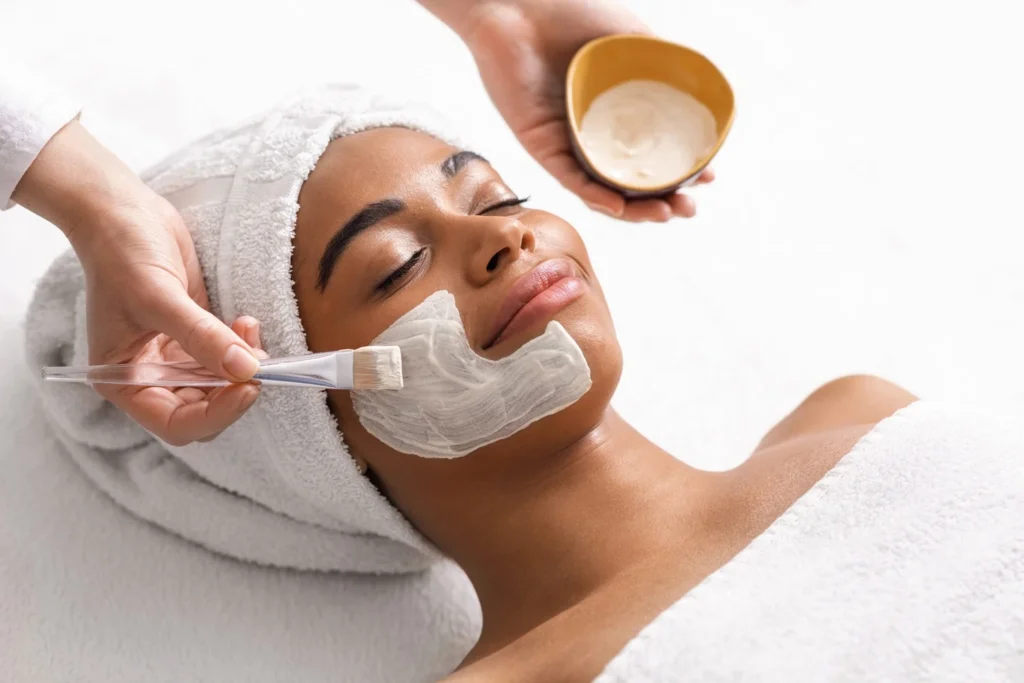 a woman getting a facial mask