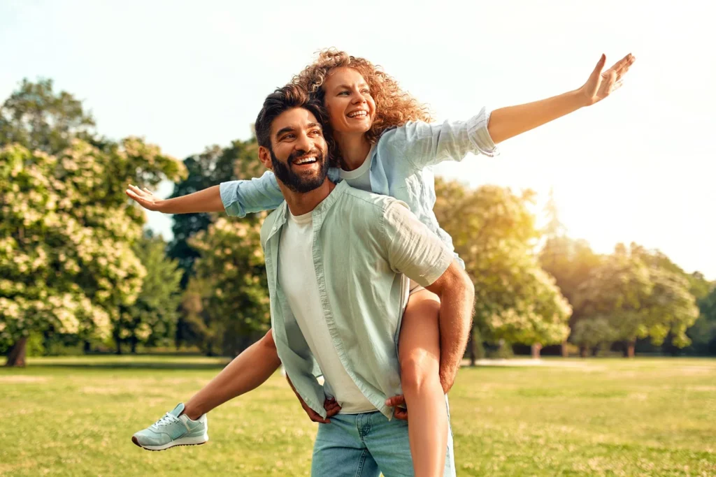 a man carrying a woman on his back