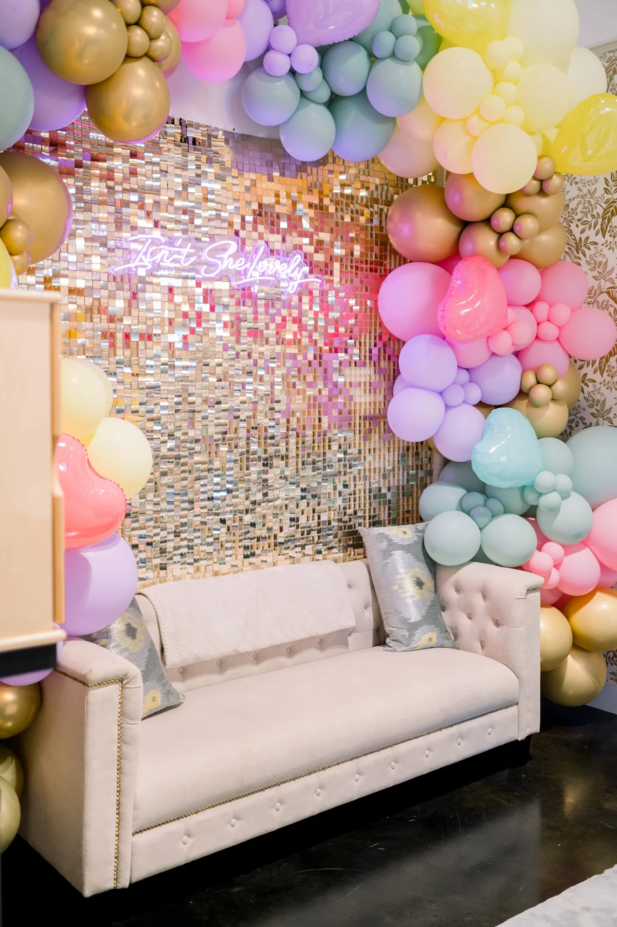 a room with a couch and balloons