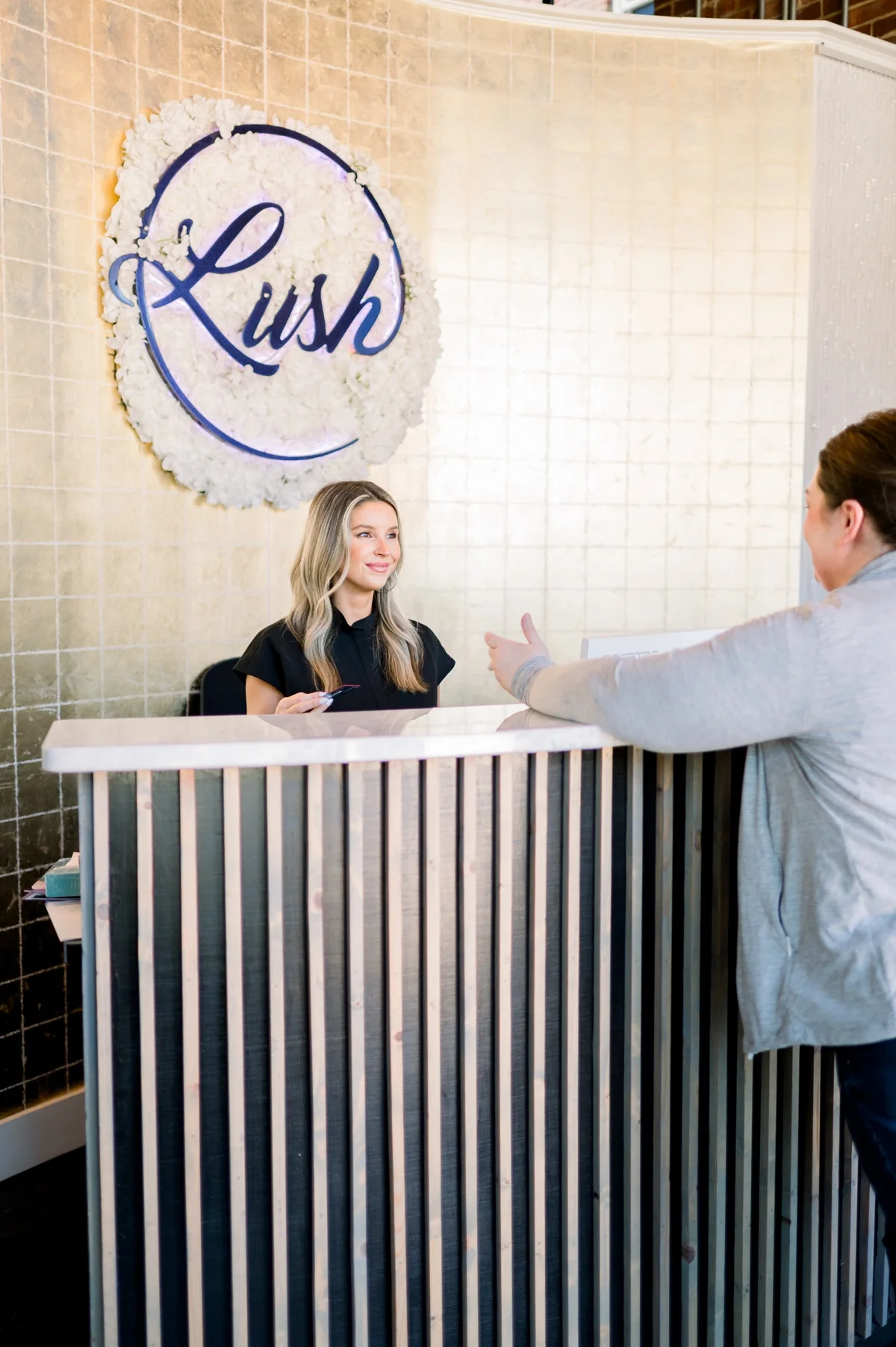 a woman standing at a reception desk