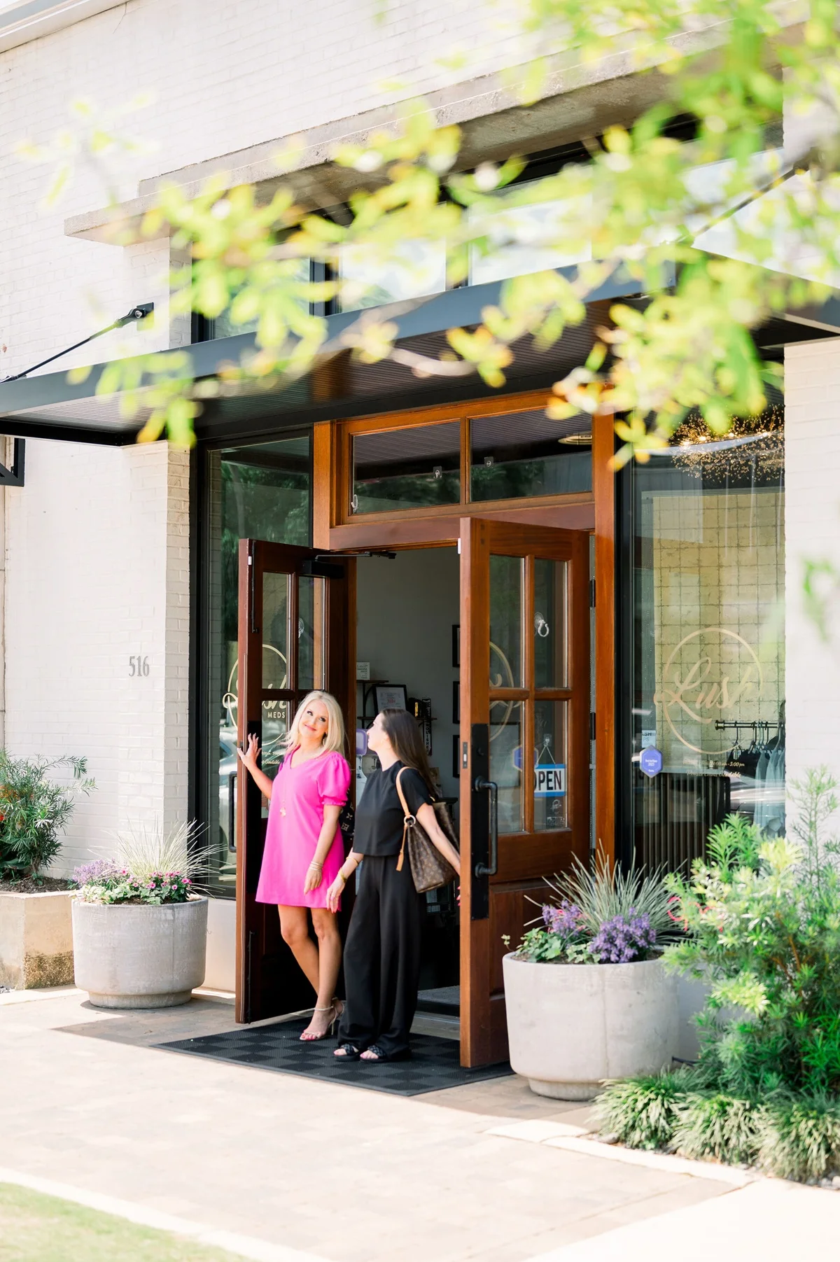 two women standing outside a building